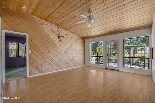 empty room with light wood-type flooring, wooden ceiling, and vaulted ceiling