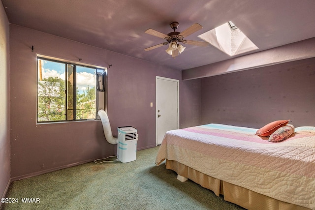 bedroom with light carpet, a skylight, and a ceiling fan