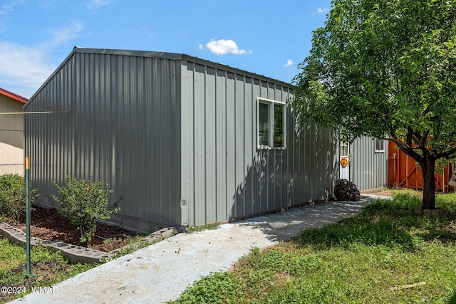 view of outbuilding featuring fence