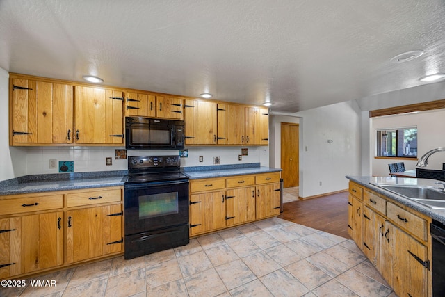 2232 Eagle Ln, Overgaard, AZ 85933 - kitchen featuring black appliances, dark countertops, brown cabinetry, and a textured ceiling