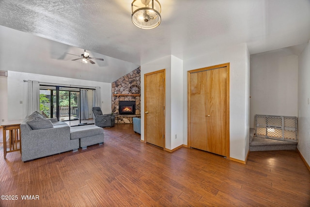 2232 Eagle Ln, Overgaard, AZ 85933 - living room featuring vaulted ceiling, wood finished floors, a ceiling fan, and a fireplace