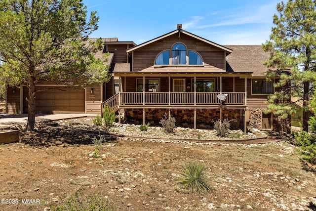 2232 Eagle Ln, Overgaard, AZ 85933 - view of front facade with covered porch, concrete driveway, and a shingled roof