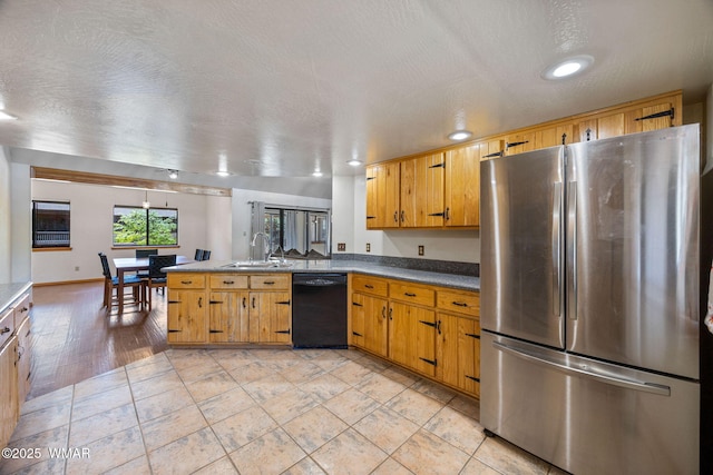 2232 Eagle Ln, Overgaard, AZ 85933 - kitchen with freestanding refrigerator, black dishwasher, a peninsula, a textured ceiling, and recessed lighting