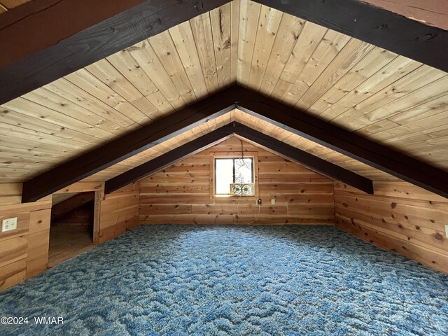 bonus room featuring vaulted ceiling with beams, wood walls, wooden ceiling, and carpet floors