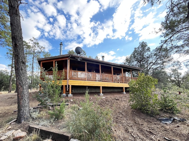 rear view of house featuring a deck