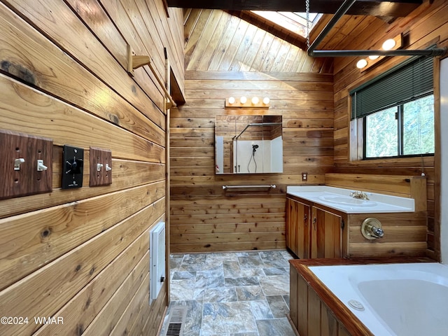 full bathroom with a skylight, wooden walls, a washtub, and vanity