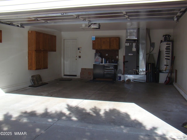 garage featuring water heater, heating unit, and a garage door opener