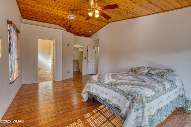 bedroom with lofted ceiling, visible vents, a spacious closet, wood ceiling, and hardwood / wood-style flooring