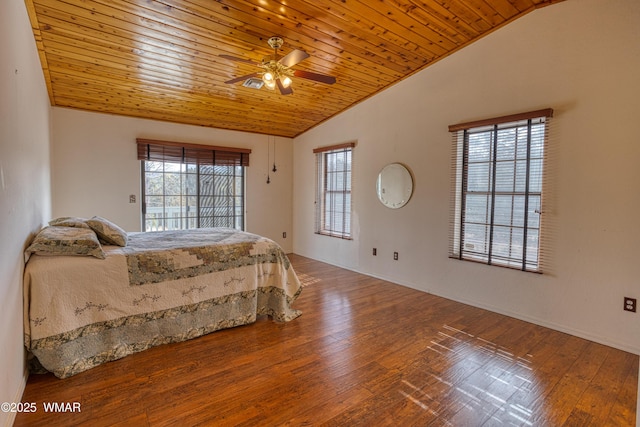 bedroom featuring vaulted ceiling, hardwood / wood-style floors, and wood ceiling