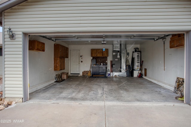 garage with a garage door opener and driveway