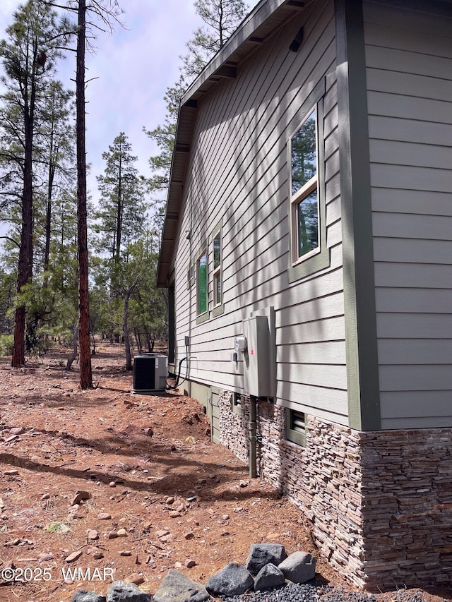 2490 Aspen Run, Pinetop, AZ 85935 - view of side of home with stone siding and central AC