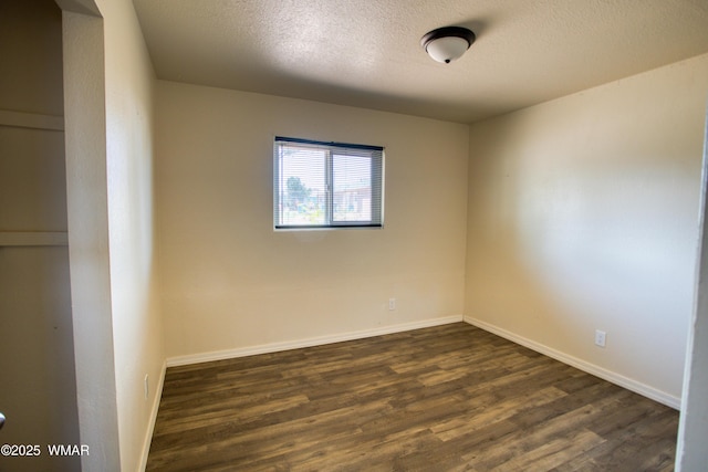 341 W 5th St S, Snowflake, AZ 85937 - spare room featuring dark wood-type flooring, baseboards, and a textured ceiling