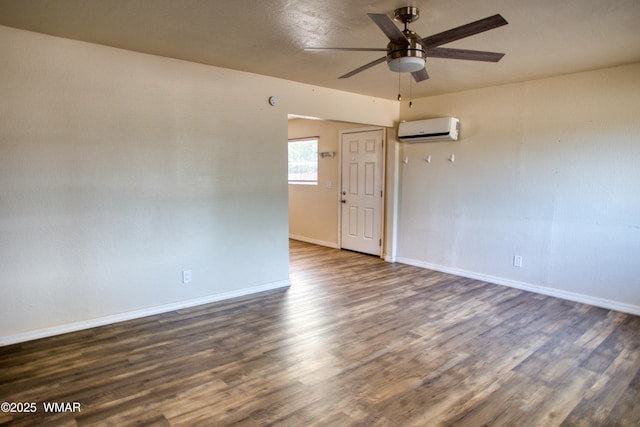 341 W 5th St S, Snowflake, AZ 85937 - unfurnished room with an AC wall unit, dark wood finished floors, a ceiling fan, and baseboards