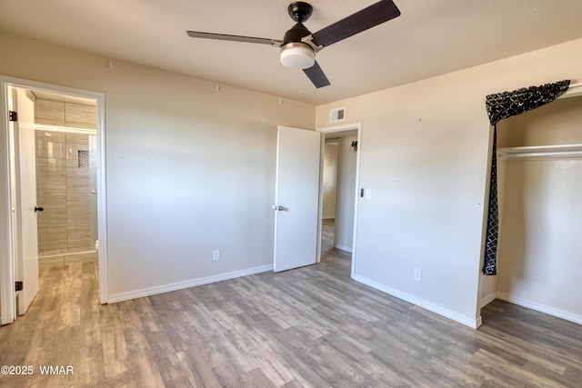 341 W 5th St S, Snowflake, AZ 85937 - unfurnished bedroom with wood finished floors, baseboards, a closet, ensuite bathroom, and ceiling fan