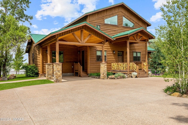 log home featuring a porch, metal roof, and log veneer siding