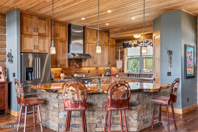 kitchen with dark wood-type flooring, wall chimney exhaust hood, wood ceiling, and appliances with stainless steel finishes