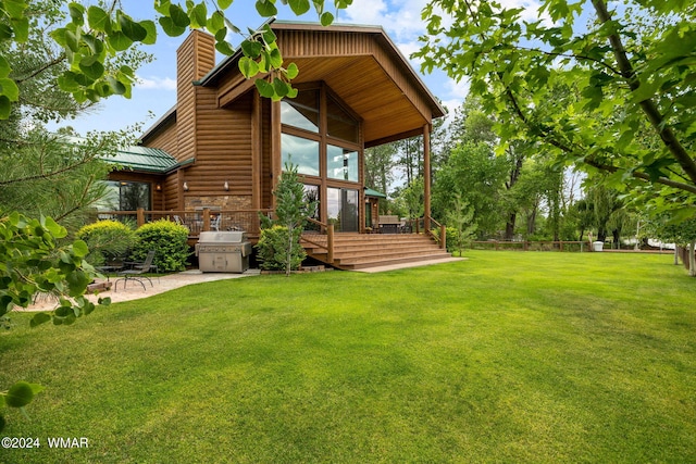 view of yard featuring a patio area and a deck