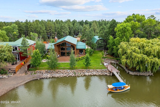 birds eye view of property featuring a view of trees and a water view