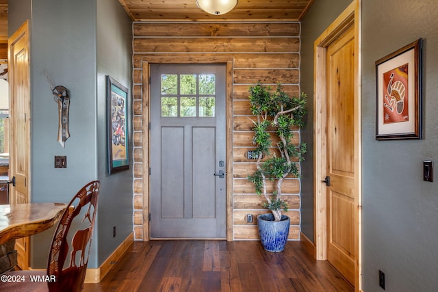 foyer with rustic walls, wood ceiling, baseboards, and wood-type flooring