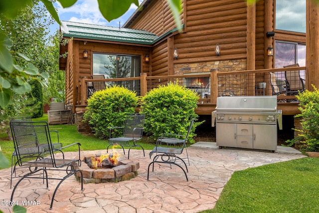 view of patio featuring a grill and an outdoor fire pit