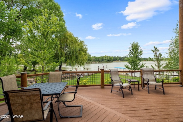 wooden deck featuring outdoor dining space and a water view