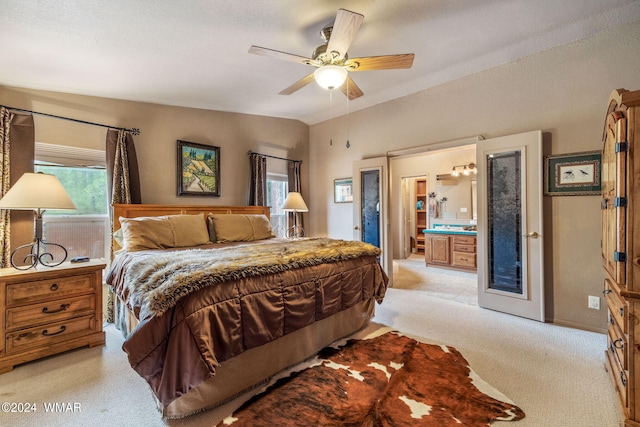 bedroom with connected bathroom, a ceiling fan, and vaulted ceiling