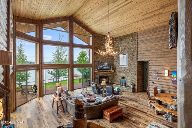 living room featuring wood ceiling, a healthy amount of sunlight, and high vaulted ceiling