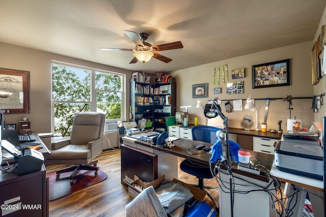 home office featuring wood finished floors and a ceiling fan