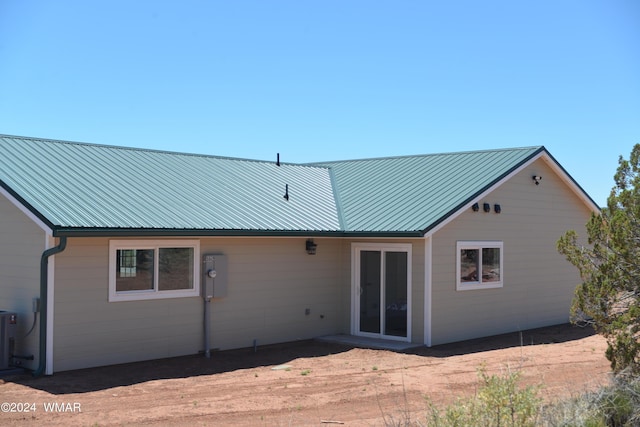 back of house with metal roof