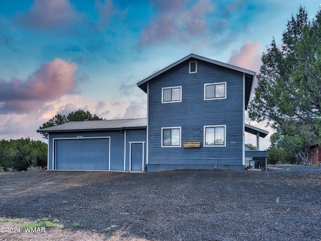 exterior space featuring crawl space, metal roof, driveway, and an attached garage