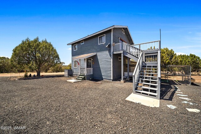 8286 Pinon Dr, Show Low, AZ 85901 - back of property featuring stairway and a wooden deck