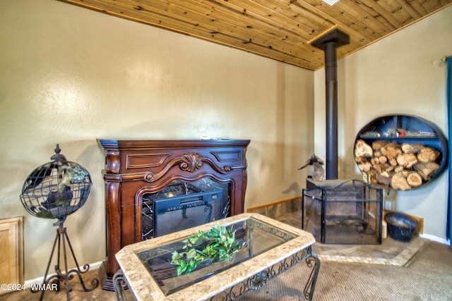 interior details featuring baseboards, a wood stove, carpet, and wood ceiling