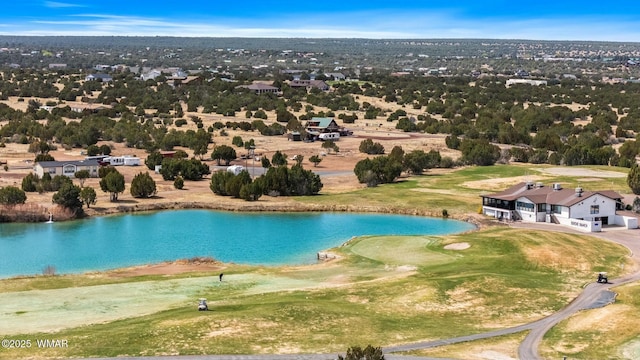 drone / aerial view with a water view and golf course view