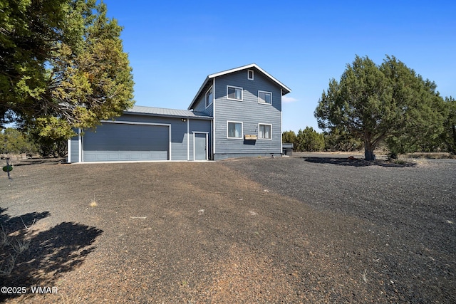 8286 Pinon Dr, Show Low, AZ 85901 - traditional home with an attached garage, metal roof, and driveway