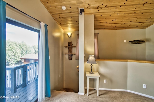 interior space featuring carpet flooring, baseboards, and wood ceiling