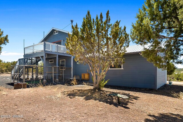 8286 Pinon Dr, Show Low, AZ 85901 - rear view of house featuring a deck and metal roof