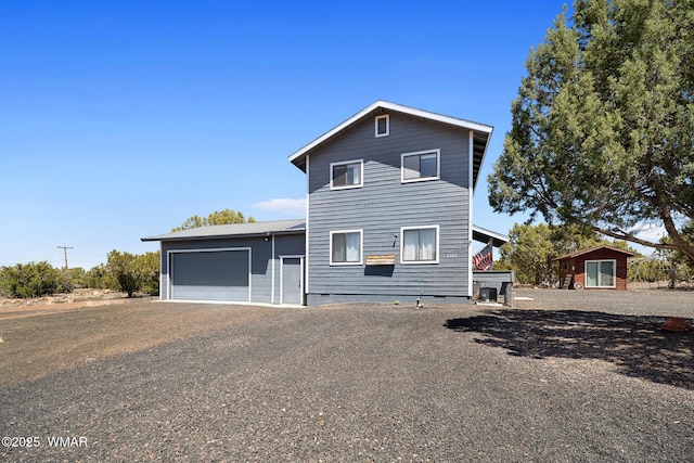 view of front of property with a garage, gravel driveway, and crawl space