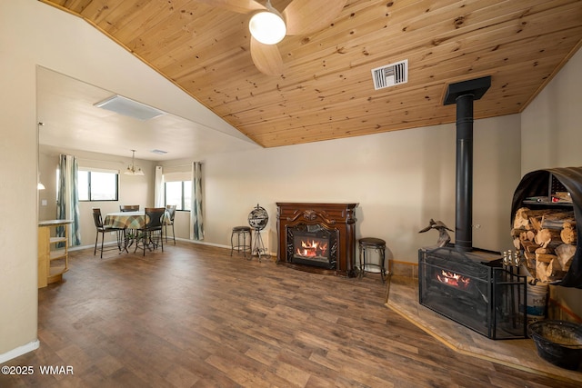 living room with baseboards, visible vents, and vaulted ceiling