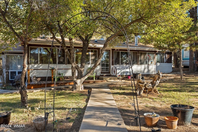 view of front of home featuring a sunroom