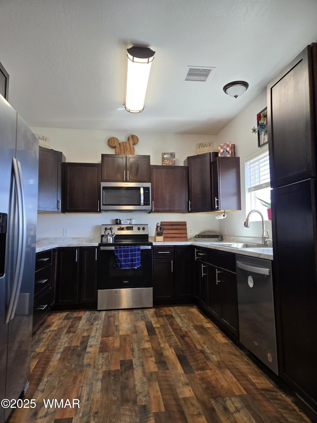 3845 Hidden Ranch Rd, Snowflake, AZ 85937 - kitchen with appliances with stainless steel finishes, a sink, light countertops, and dark wood-style flooring