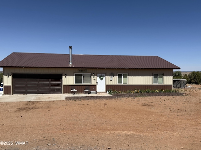 3845 Hidden Ranch Rd, Snowflake, AZ 85937 - view of front of property featuring an attached garage, metal roof, and dirt driveway
