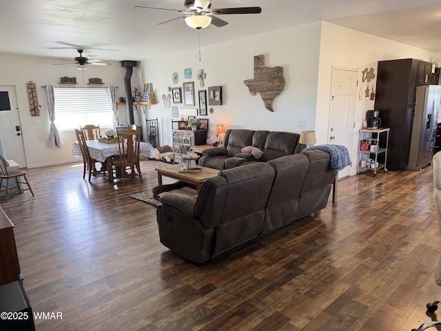 3845 Hidden Ranch Rd, Snowflake, AZ 85937 - living room featuring ceiling fan, a wood stove, and dark wood-type flooring