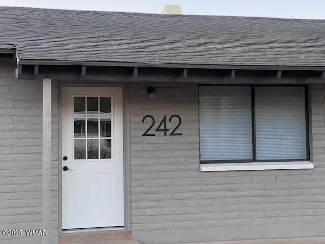 242 E 7th Ave, Eagar, AZ 85925 - doorway to property with roof with shingles