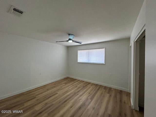 242 E 7th Ave, Eagar, AZ 85925 - unfurnished bedroom with wood finished floors, a closet, and ceiling fan