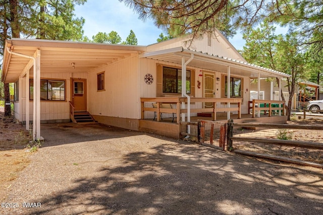 1721 W Huning, Show Low, AZ 85901 - view of front of home with a porch, a carport, driveway, and entry steps