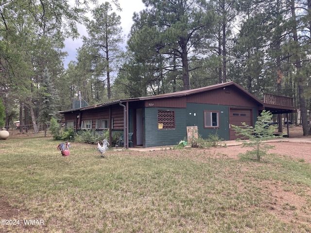 view of side of property featuring a garage and a yard