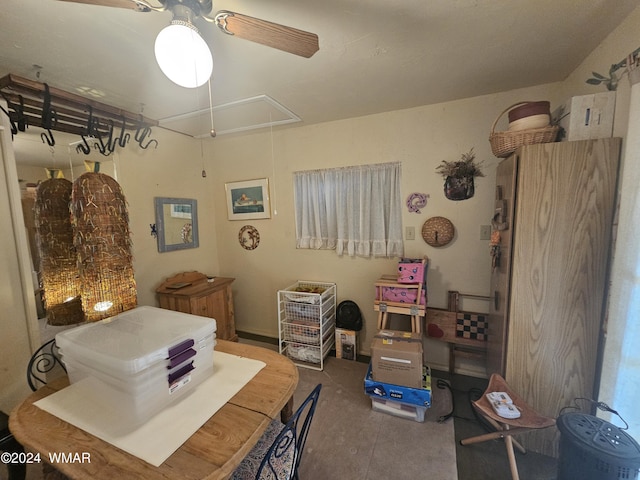 dining space featuring attic access and a ceiling fan