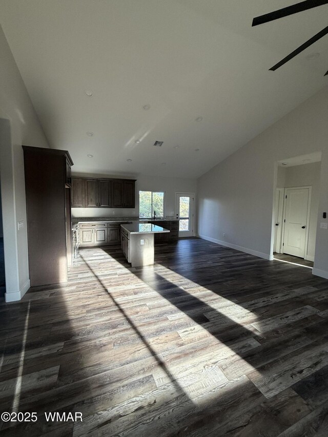 2747 Air Park Dr, Overgaard, AZ 85933 - interior space featuring visible vents, dark wood finished floors, baseboards, open floor plan, and lofted ceiling
