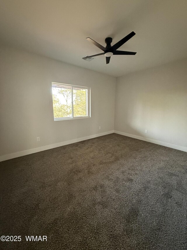 2747 Air Park Dr, Overgaard, AZ 85933 - unfurnished room with baseboards, ceiling fan, and dark colored carpet
