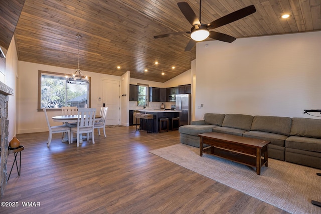 living area with vaulted ceiling, ceiling fan, wood ceiling, a chandelier, and dark wood finished floors